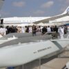 Emirati and foreign visitors pass behind