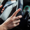 A woman is driving, women’s hands are on the handlebars.